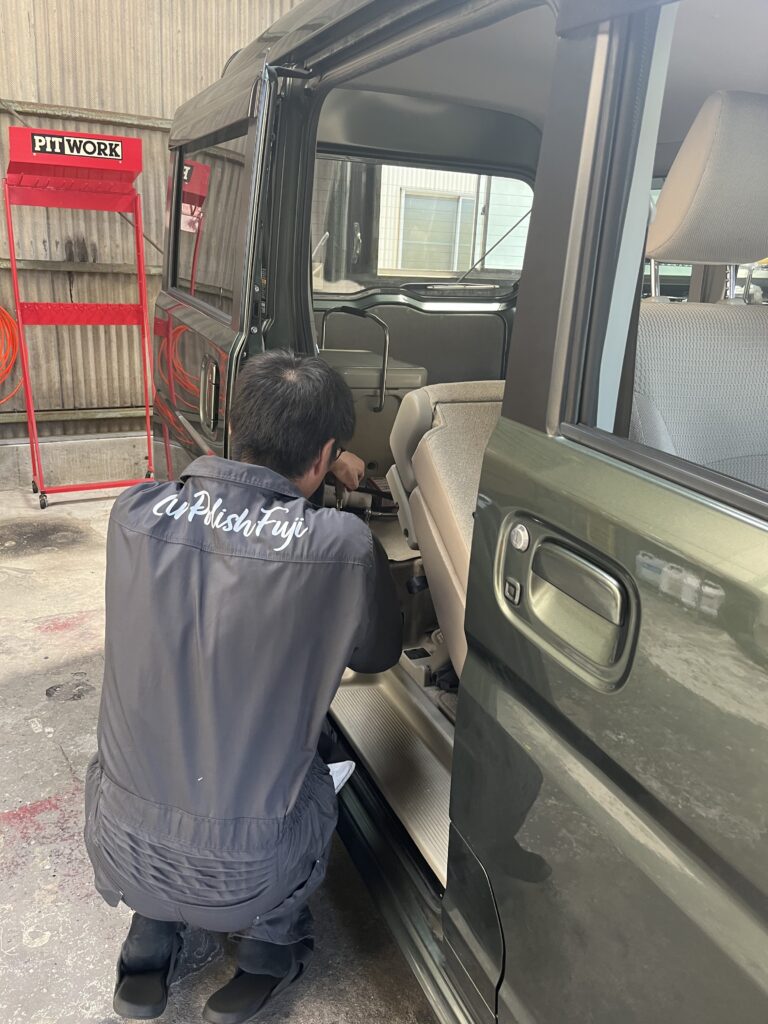 Inspection of rear cabin area in a Japanese kei van with sliding door open